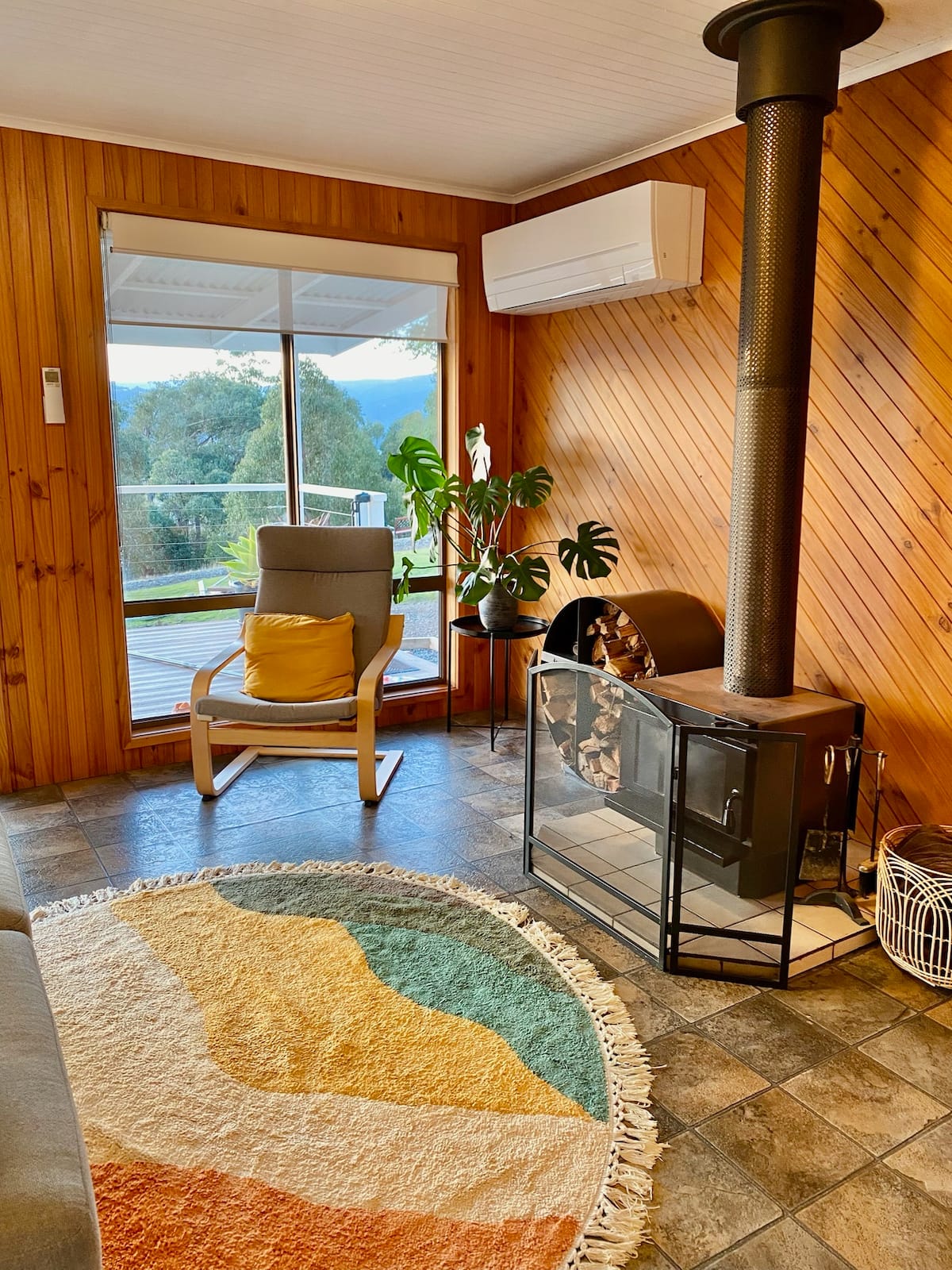 Armchair beside the fireplace with valley views