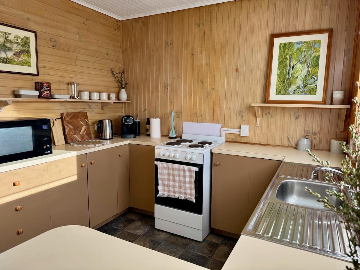 Compact timber kitchen with oven and microwave