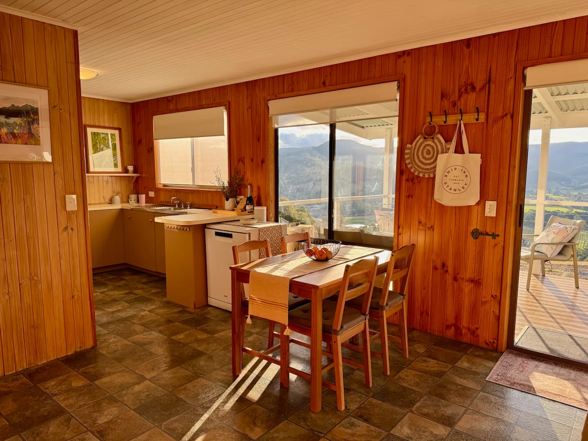 Dining table and kitchen with valley outlook